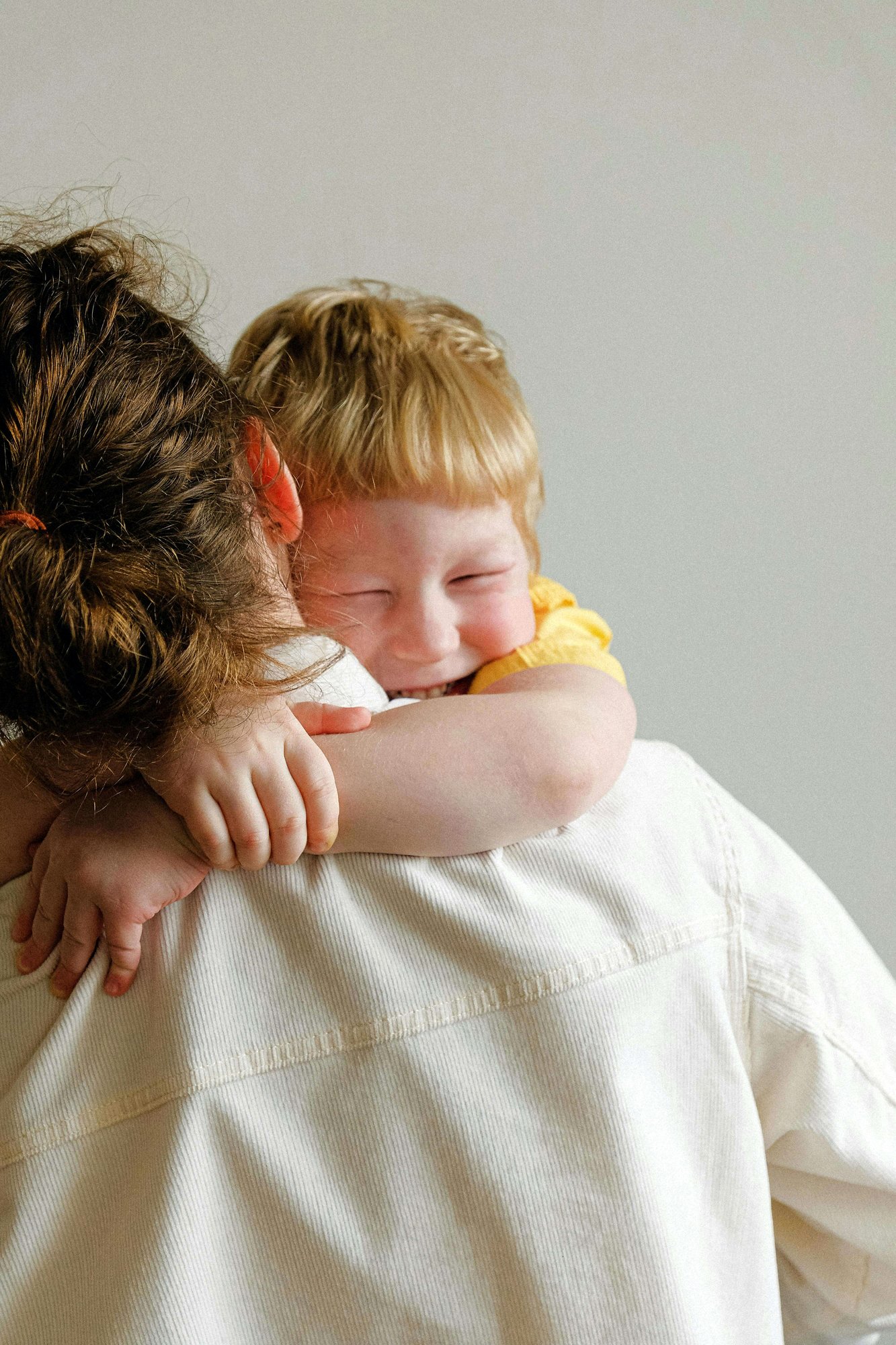 a toddler hugging their parent